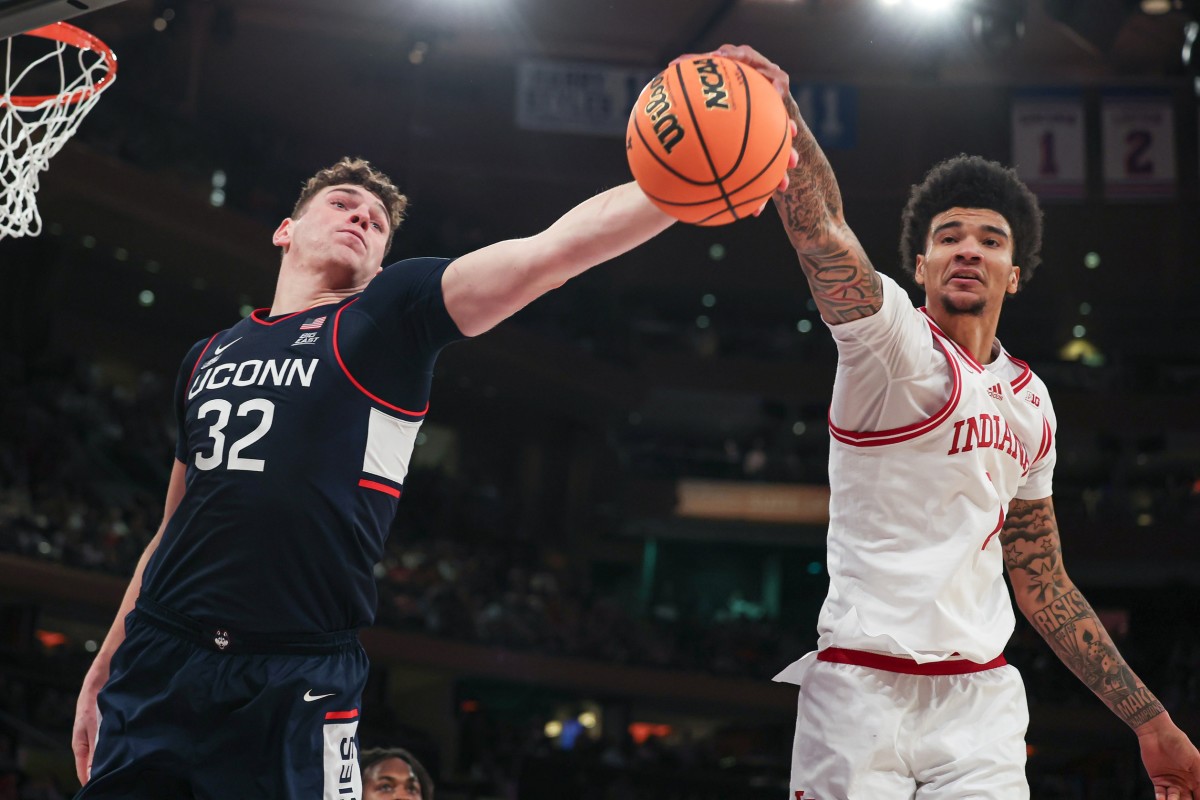 Connecticut Huskies center Donovan Clingan (32) and Indiana Hoosiers center Kel'el Ware (1) reach for a rebound during the second half at Madison Square Garden.