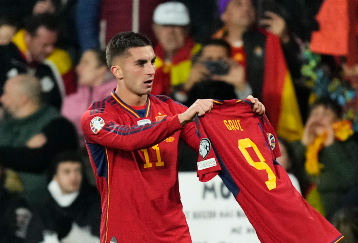 Ferran Torres pictured holding up the jersey of Spain teammate Gavi after scoring in a 3-1 win over Georgia in November 2023