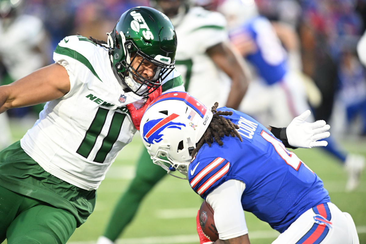 New York Jets linebacker Jermaine Johnson (11) prepares for a tackle on Buffalo Bills running back James Cook (4) in the first quarter at Highmark Stadium.