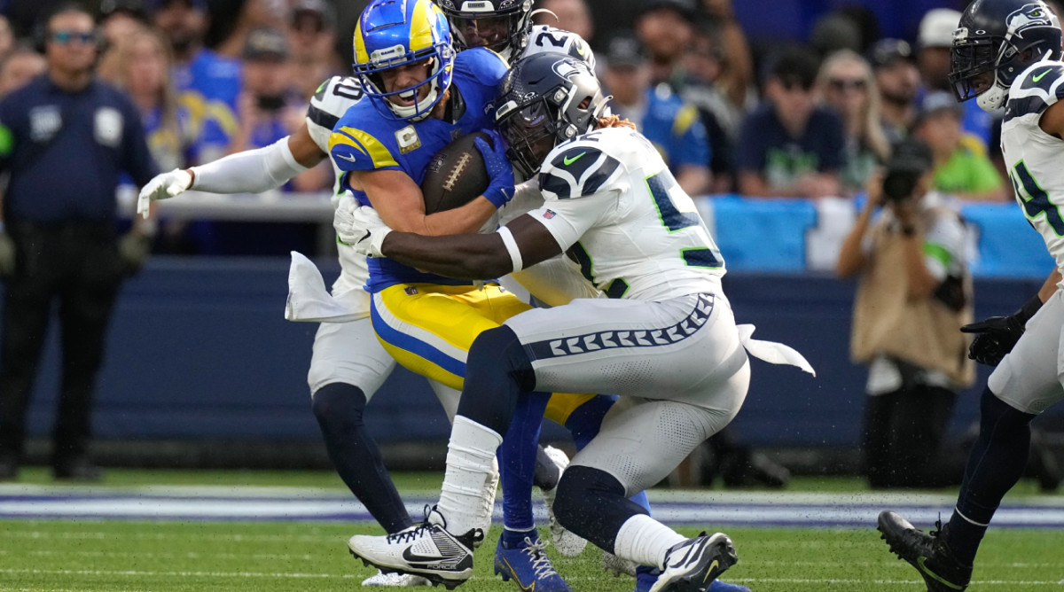Los Angeles Rams wide receiver Cooper Kupp, left, is tackled while running the ball during the first half of an NFL football game Sunday, Nov. 19, 2023, in Inglewood, Calif. (AP Photo/Mark J. Terrill)   