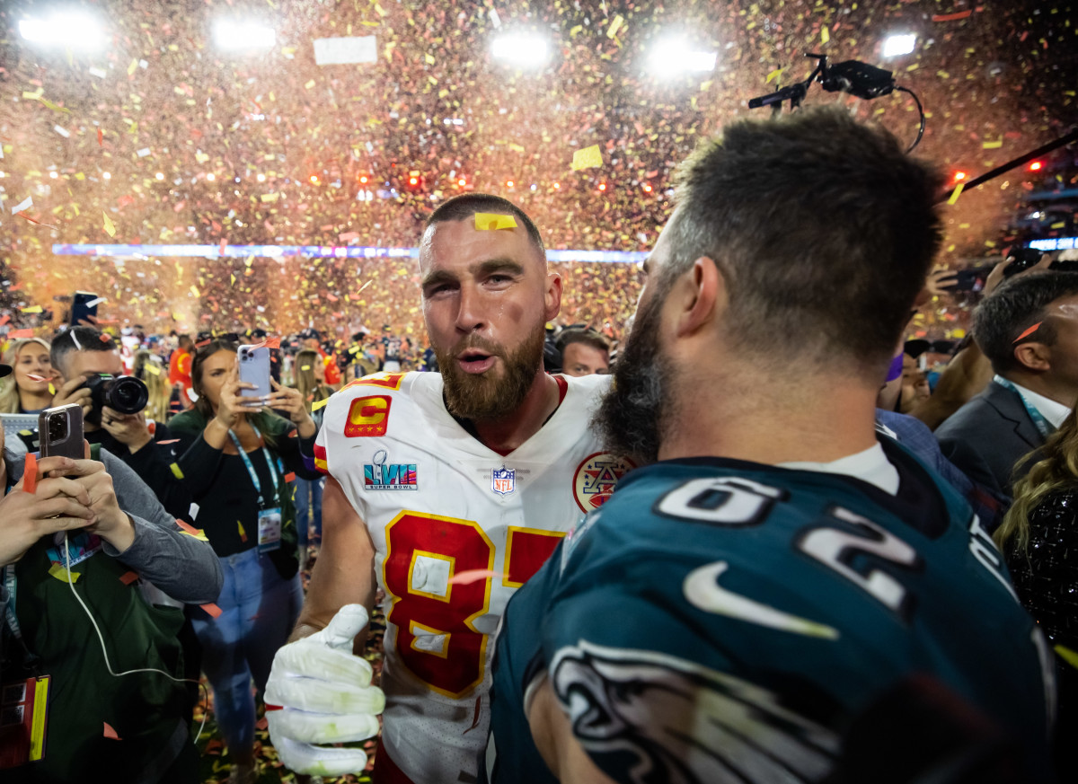 Kansas City Chiefs tight end Travis Kelce talks with his brother, Philadelphia Eagles center, Jason Kelce after Super Bowl LVII at State Farm Stadium.