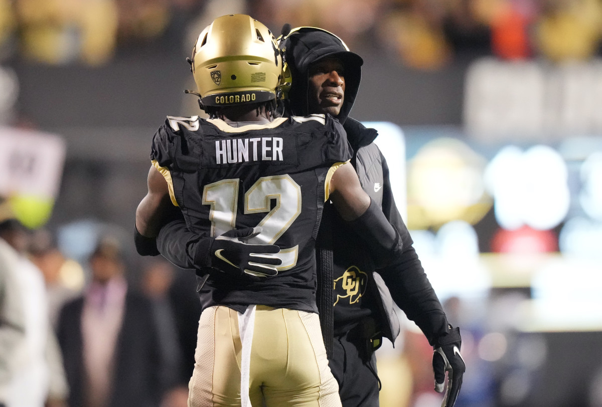 Colorado Buffaloes wide receiver Travis Hunter (12) is congratulated for his touchdown by head coach Deion Sanders in the first quarter against the Stanford Cardinal at Folsom Field