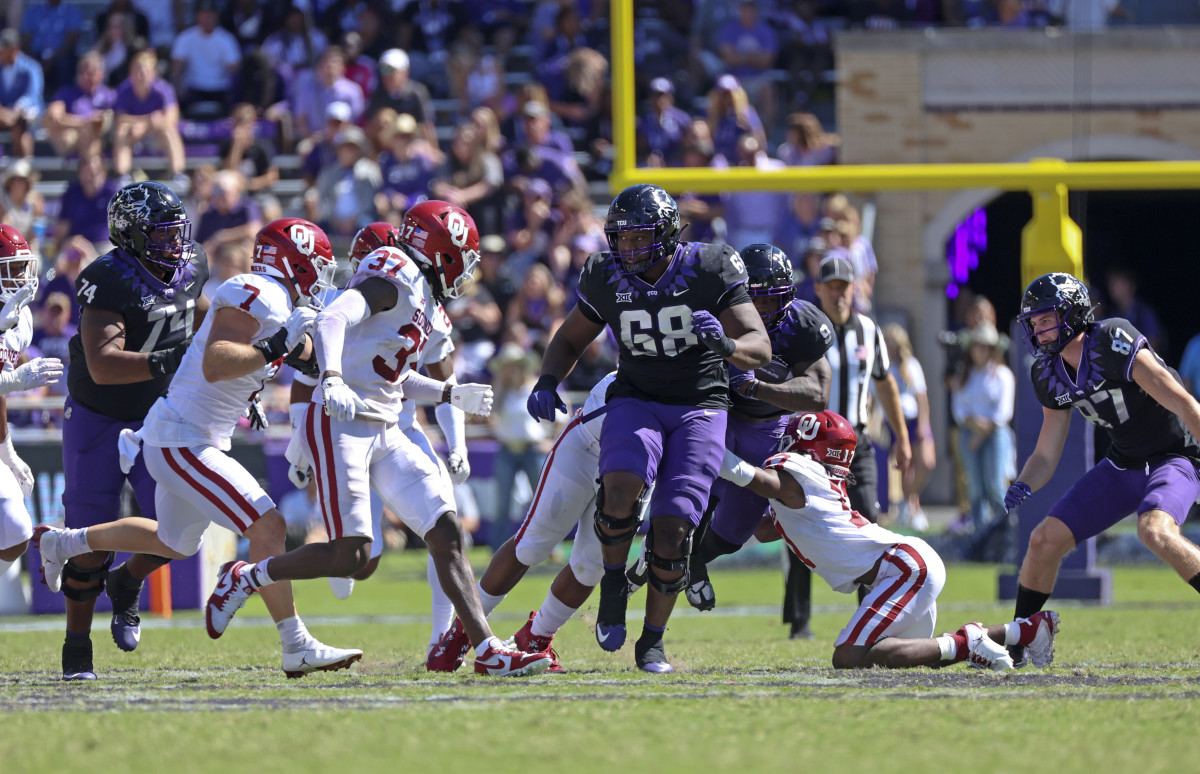 Oct 1, 2022; Fort Worth, Texas, USA; Oklahoma Sooners defensive back Damond Harmon (17) injures himself as TCU Horned Frogs running back Emani Bailey (9) runs with the ball during the second half at Amon G. Carter Stadium. Mandatory Credit: Kevin Jairaj-USA TODAY Sports