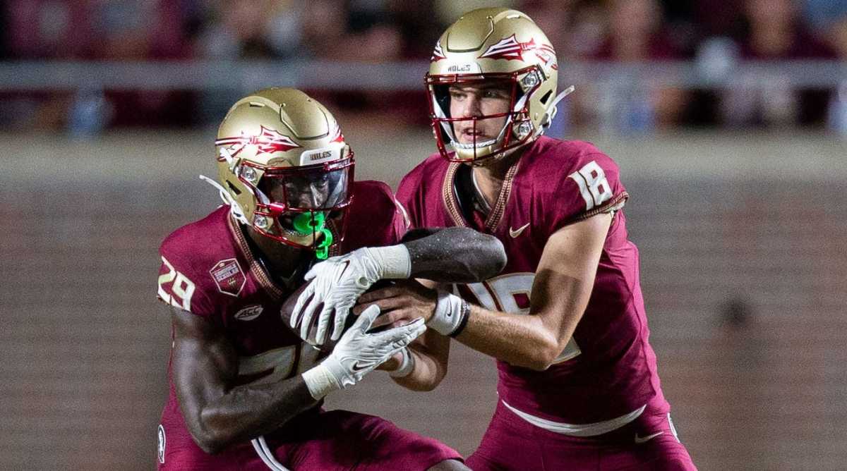 Florida State quarterback Tate Rodemaker, right, hands the ball to running back Rodney Hill.