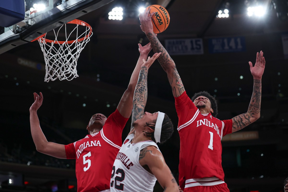 Louisville Cardinals guard Tre White (22) rebounds against Indiana Hoosiers forward Malik Reneau (5) and center Kel'el Ware (1) during the first half at Madison Square Garden.