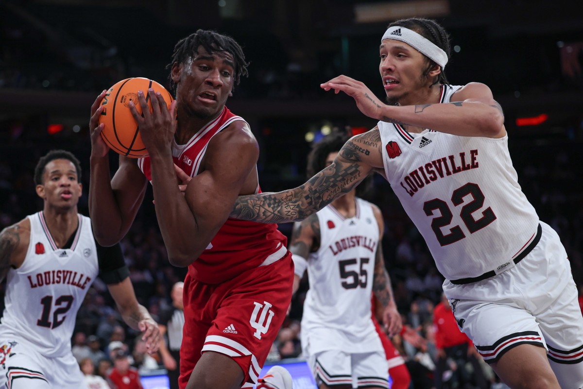  Indiana Hoosiers forward Kaleb Banks (10) rebounds against Louisville Cardinals guard Tre White (22) during the second half at Madison Square Garden.