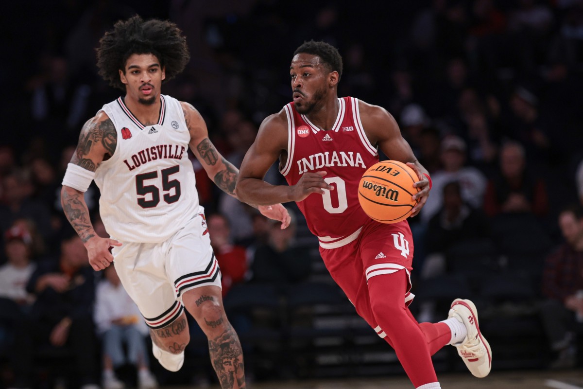  Indiana Hoosiers guard Xavier Johnson (0) dribbles up court in front of Louisville Cardinals guard Skyy Clark (55) during the second half at Madison Square Garden. 