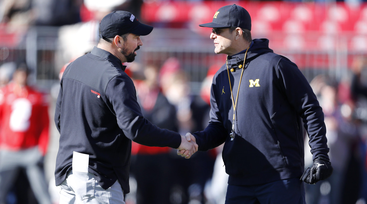 Michigan Wolverines head coach Jim Harbaugh and Ohio State Buckeyes head coach Ryan Day shake hands.