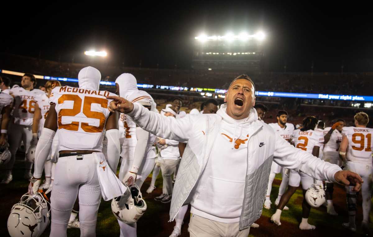Steve Sarkisian and the Texas Longhorns celebrate after beating Iowa State