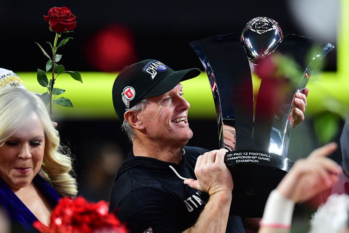 December 3, 2021; Las Vegas, NV, USA; Utah Utes head coach Kyle Whittingham raises the championship trophy following the victory against the Oregon Ducks in the 2021 Pac-12 Championship Game at Allegiant Stadium. Mandatory Credit: Gary A. Vasquez-USA TODAY Sports