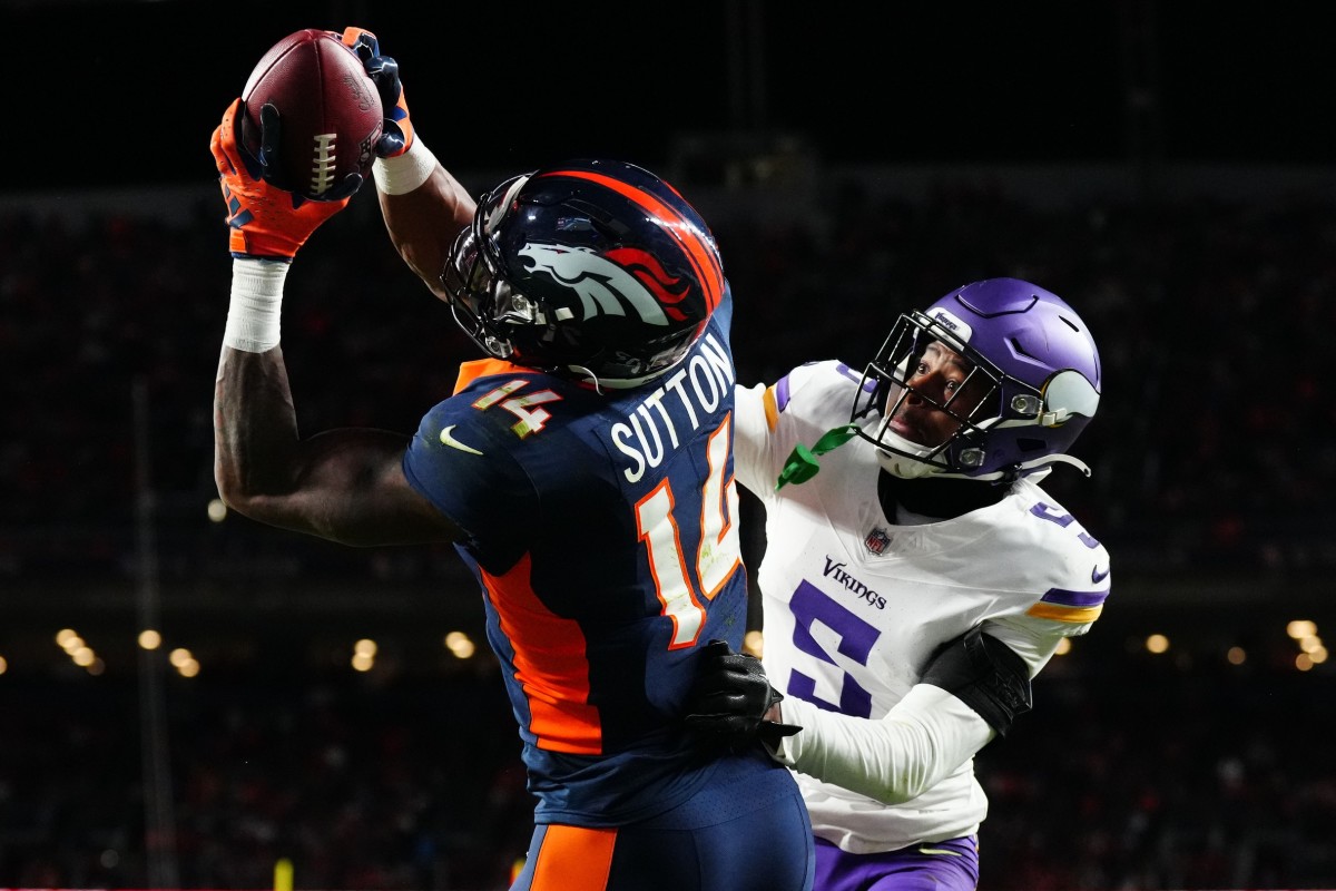 Denver Broncos wide receiver Courtland Sutton (14) catches a touchdown over Minnesota Vikings cornerback Mekhi Blackmon (5) in the fourth quarter at Empower Field at Mile High.