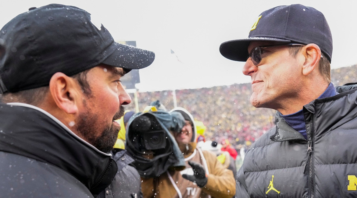 Ryan Day greets Jim Harbaugh after Michigan defeats Ohio State in 2021.