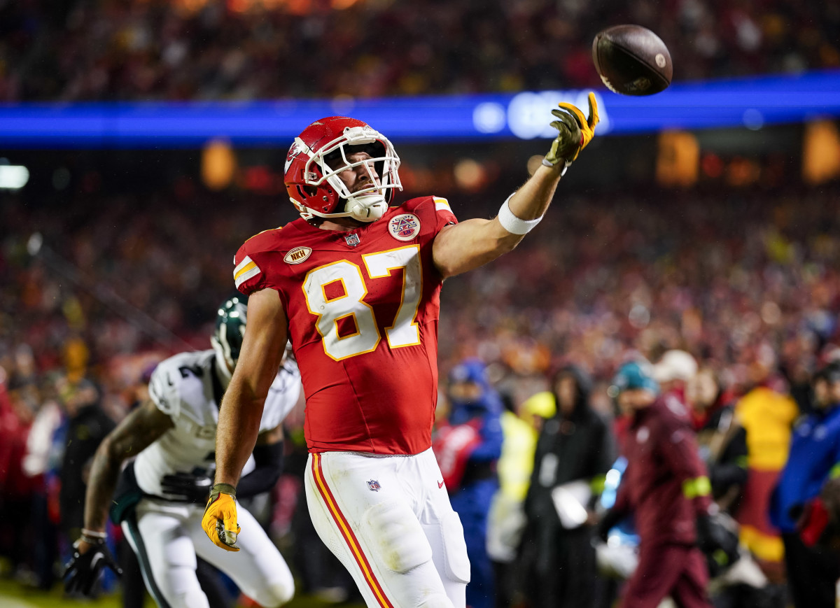 Kansas City Chiefs tight end Travis Kelce tosses the ball after scoring a touchdown against Philadelphia Eagles during the first half at GEHA Field at Arrowhead Stadium.