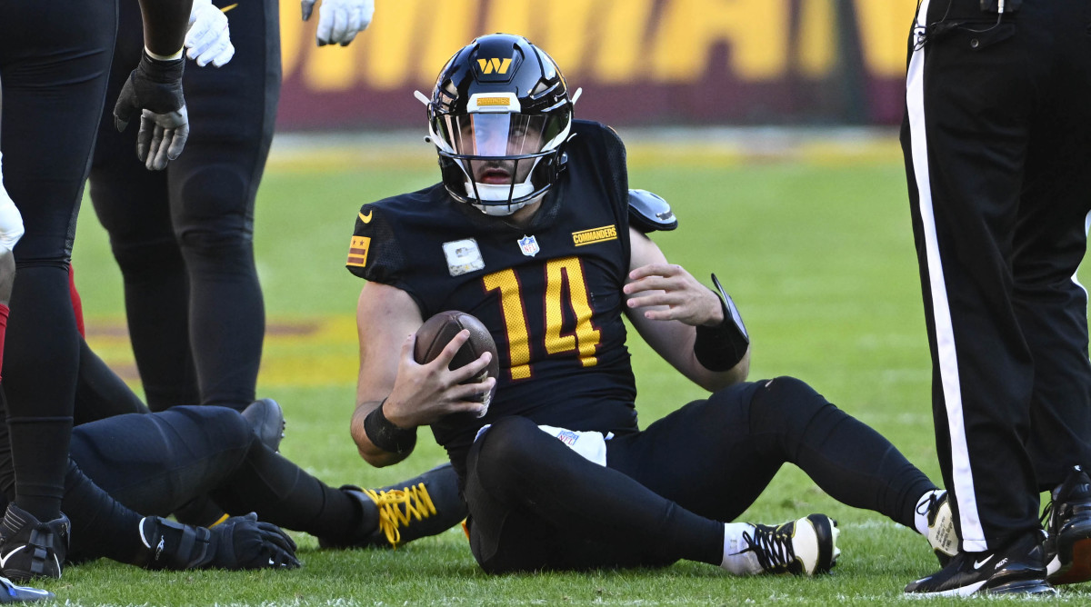 Commanders QB Sam Howell sits on the ground after being sacked