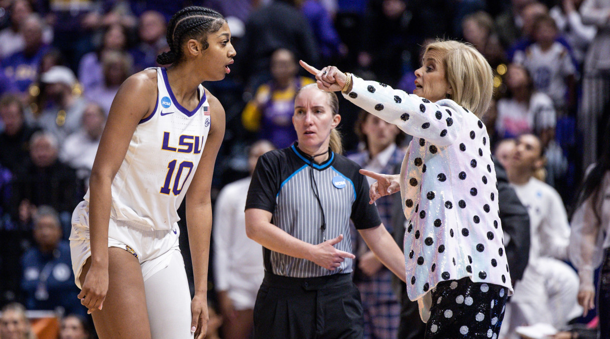 Tigers head coach Kim Mulkey gives directions to forward Angel Reese while playing Michigan.