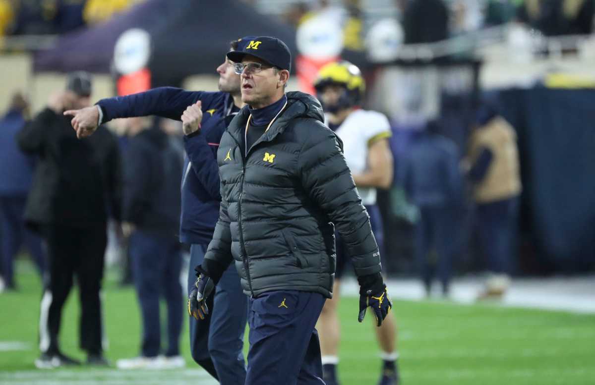 Jim Harbaugh walks on the field