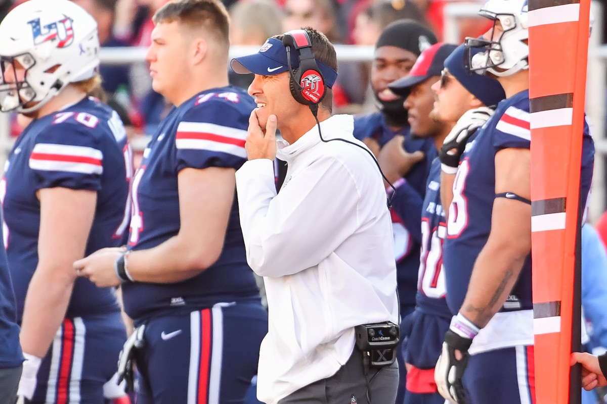 Jamey Chadwell puts one hand up to his chin as he watches on the sideline