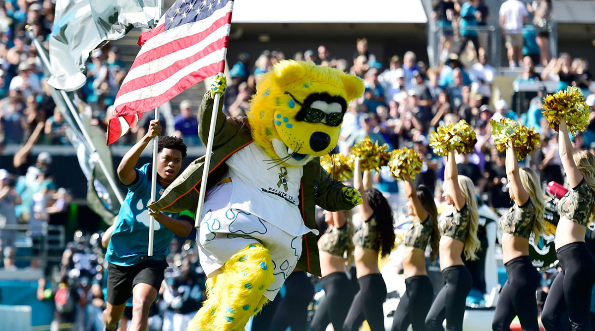 Jaguars mascot Jaxson de Ville runs onto the field with an American flag