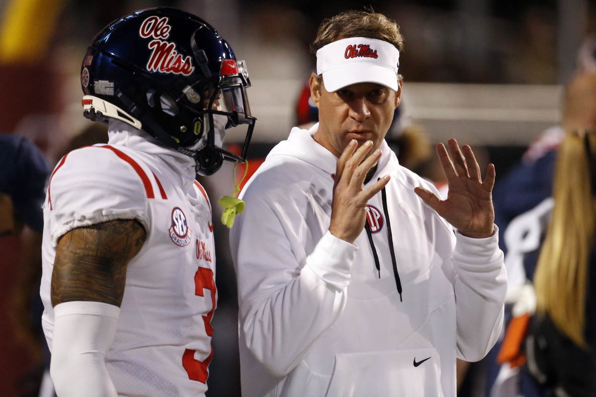 Nov 23, 2023; Starkville, Mississippi, USA; Mississippi Rebels head coach Lane Kiffin (right) talks with defensive back Daijahn Anthony (3) prior to the game against the Mississippi State Bulldogs at Davis Wade Stadium at Scott Field. Mandatory Credit: Petre Thomas-USA TODAY Sports  