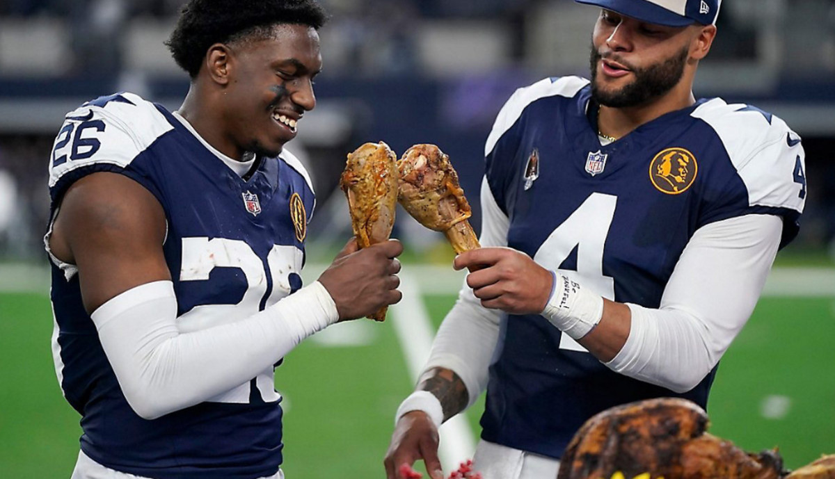 Bland and Cowboys quarterback Dak Prescott enjoy celebratory turkey legs after Thursday's win.