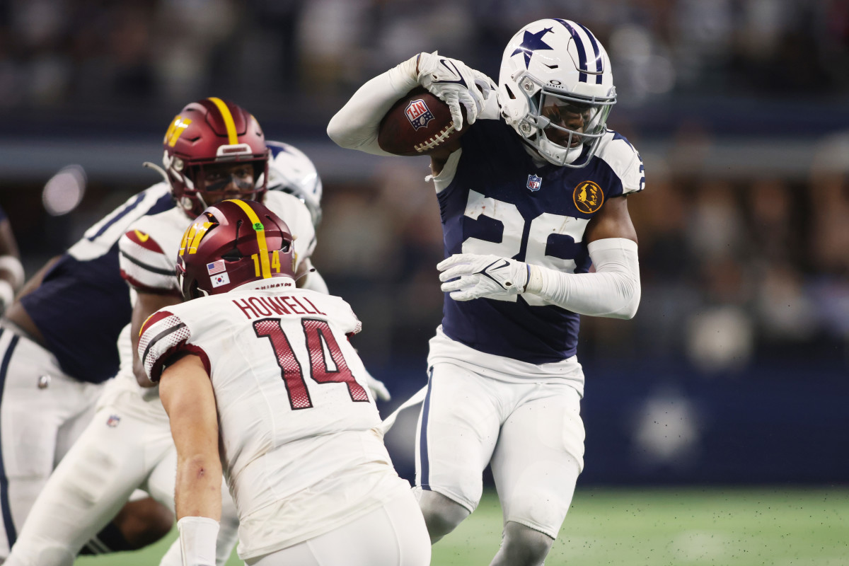 Nov 23, 2023; Arlington, Texas, USA; Dallas Cowboys cornerback DaRon Bland (26) returns an interception for a touchdown in the fourth quarter against Washington Commanders quarterback Sam Howell (14) at AT&T Stadium. Mandatory Credit: Tim Heitman-USA TODAY Sports