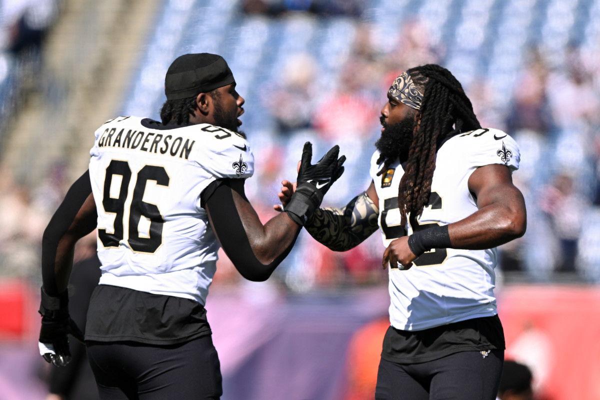 New Orleans Saints defensive tackle Demario Davis (56) high-fives defensive end Carl Granderson (96) during warmups