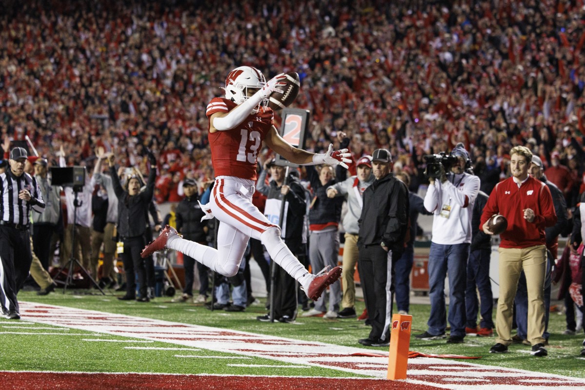 Nov 26, 2022; Madison, Wisconsin, USA; Wisconsin Badgers wide receiver Chimere Dike (13) rushes for a touchdown after catching a pass during the third quarter against the Minnesota Golden Gophers at Camp Randall Stadium. Mandatory Credit: Jeff Hanisch-USA TODAY Sports