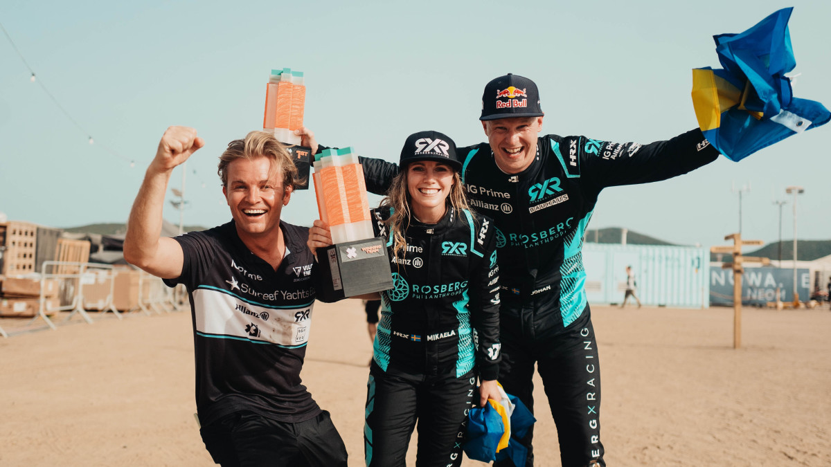 Nico Rosberg celebrates with the drivers of his Extreme E series team.