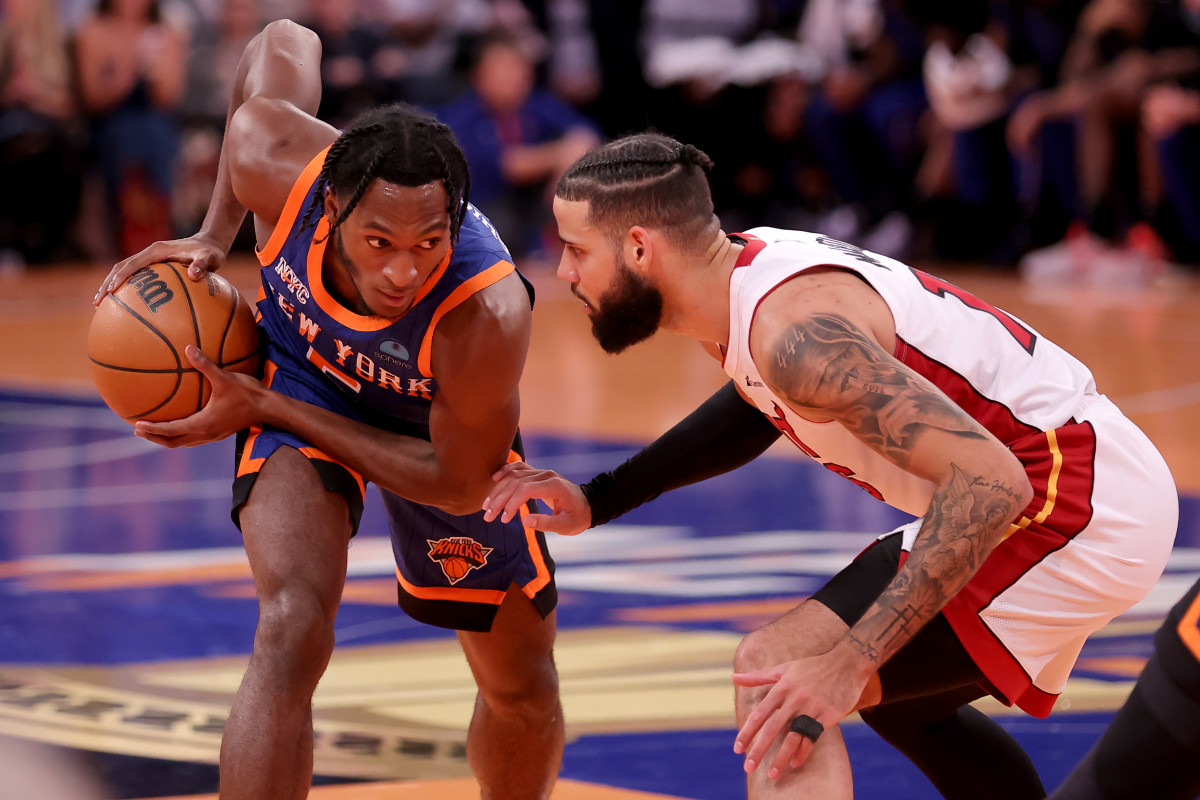 New York Knicks guard Immanuel Quickley defended by Miami Heat forward Caleb Martin