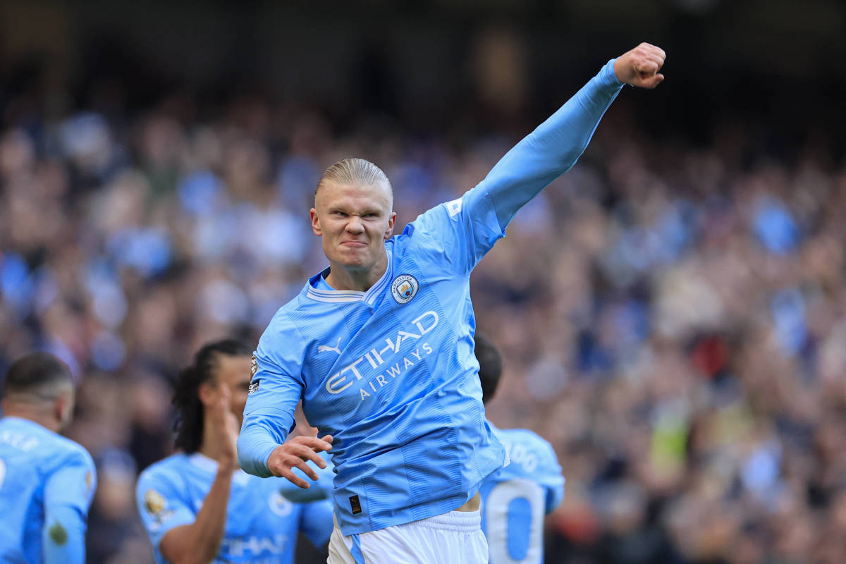 Erling Haaland pictured celebrating after scoring the 50th goal of his Premier League career during a game between Manchester City and Liverpool in November 2023