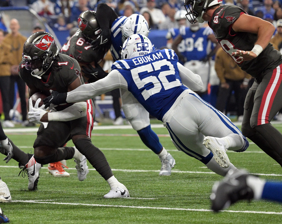 Nov 26, 2023; Indianapolis, Indiana, USA; Indianapolis Colts defensive end Samson Ebukam (52) reaches to tackle Tampa Bay Buccaneers running back Rachaad White (1) during the first quarter at Lucas Oil Stadium. Mandatory Credit: Marc Lebryk-USA TODAY Sports