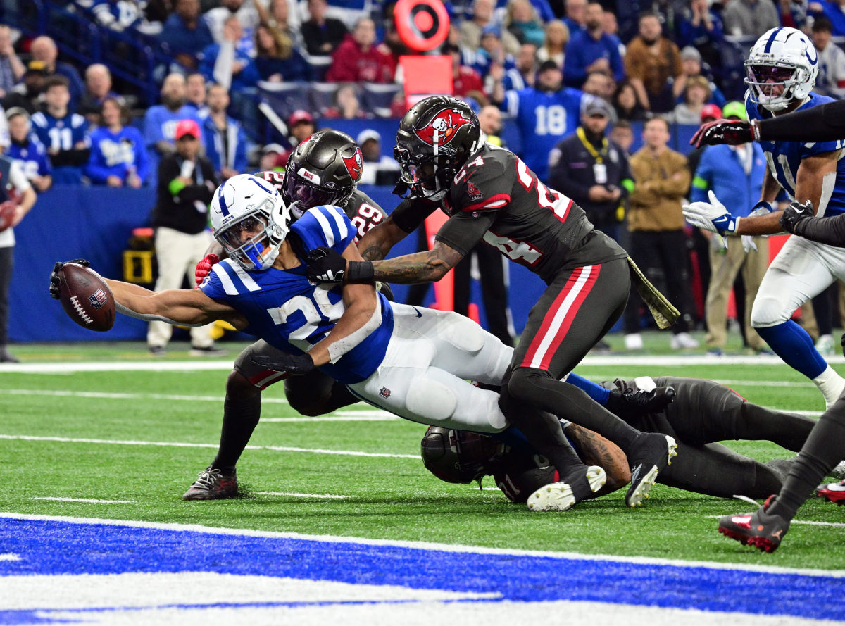 Nov 26, 2023; Indianapolis, Indiana, USA; Indianapolis Colts running back Jonathan Taylor (28) drives for a touchdown but falls short for a first down against Tampa Bay Buccaneers cornerback Carlton Davis III (24) and safety Christian Izien (29) at Lucas Oil Stadium.