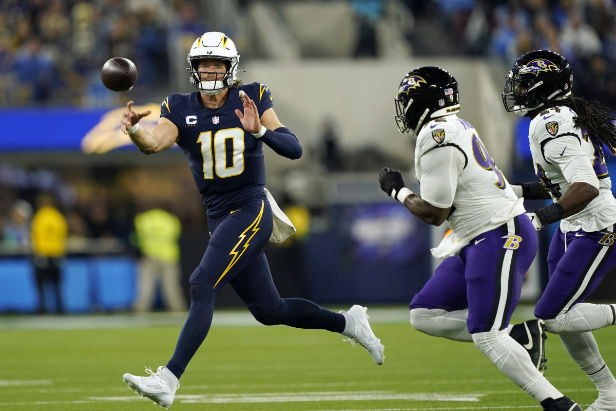 Los Angeles Chargers quarterback Justin Herbert throws on the run during the first half against the Baltimore Ravens at Sofi Stadium.
