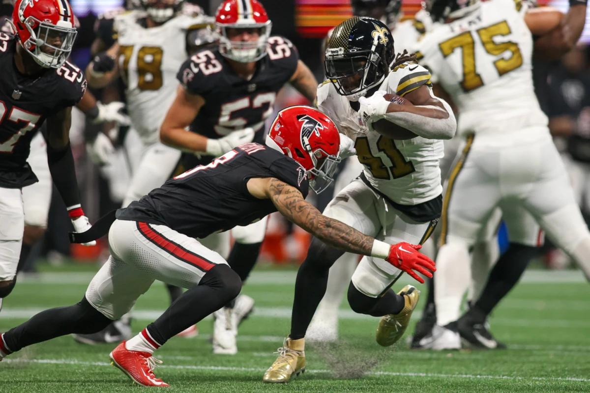 Atlanta Falcons safety Jessie Bates III tackling New Orleans Saints star running back Alvin Kamara.
