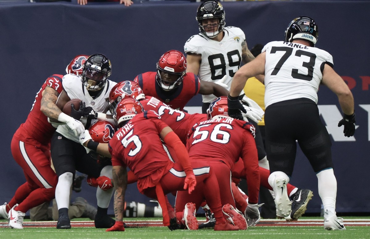 Jaguars running back Travis Etienne is stuffed by Texans defenders with one second left in the first half of their AFC South matchup in Week 12.