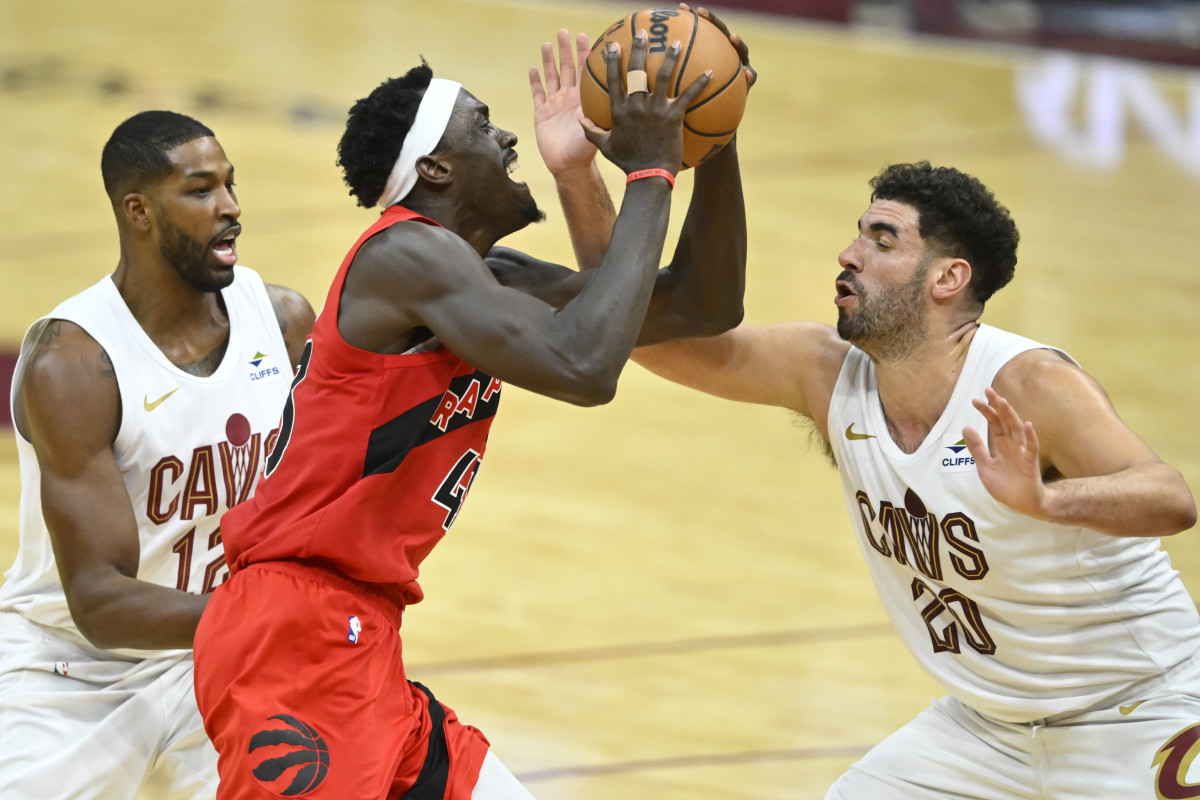 Nov 26, 2023; Cleveland, Ohio, USA; Toronto Raptors forward Pascal Siakam (43) drives between Cleveland Cavaliers center Tristan Thompson (12) and forward Georges Niang (20) in the third quarter at Rocket Mortgage FieldHouse.