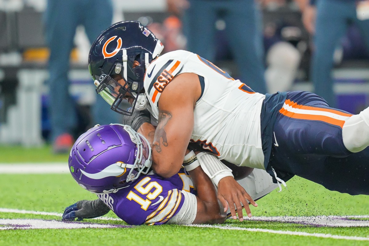 Nov 27, 2023; Minneapolis, Minnesota, USA; Chicago Bears defensive end Montez Sweat (98) sacks Minnesota Vikings quarterback Joshua Dobbs (15) in the first quarter at U.S. Bank Stadium. 