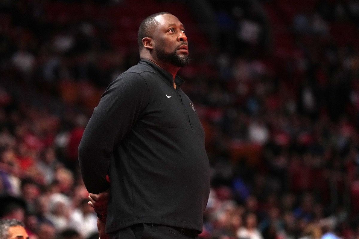 Milwaukee Bucks head coach Adrian Griffin stands on the court 