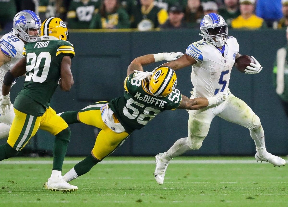 Detroit Lions running back David Montgomery (5) stiff-arms Green Bay Packers linebacker Isaiah McDuffie (58). Tork Mason/USA TODAY NETWORK-Wisconsin