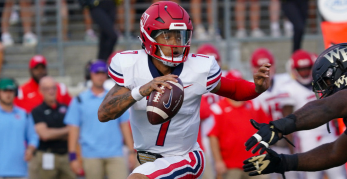 Liberty Flames quarterback Kaidon Salter on a rushing attempt during a college football game in Conference USA.