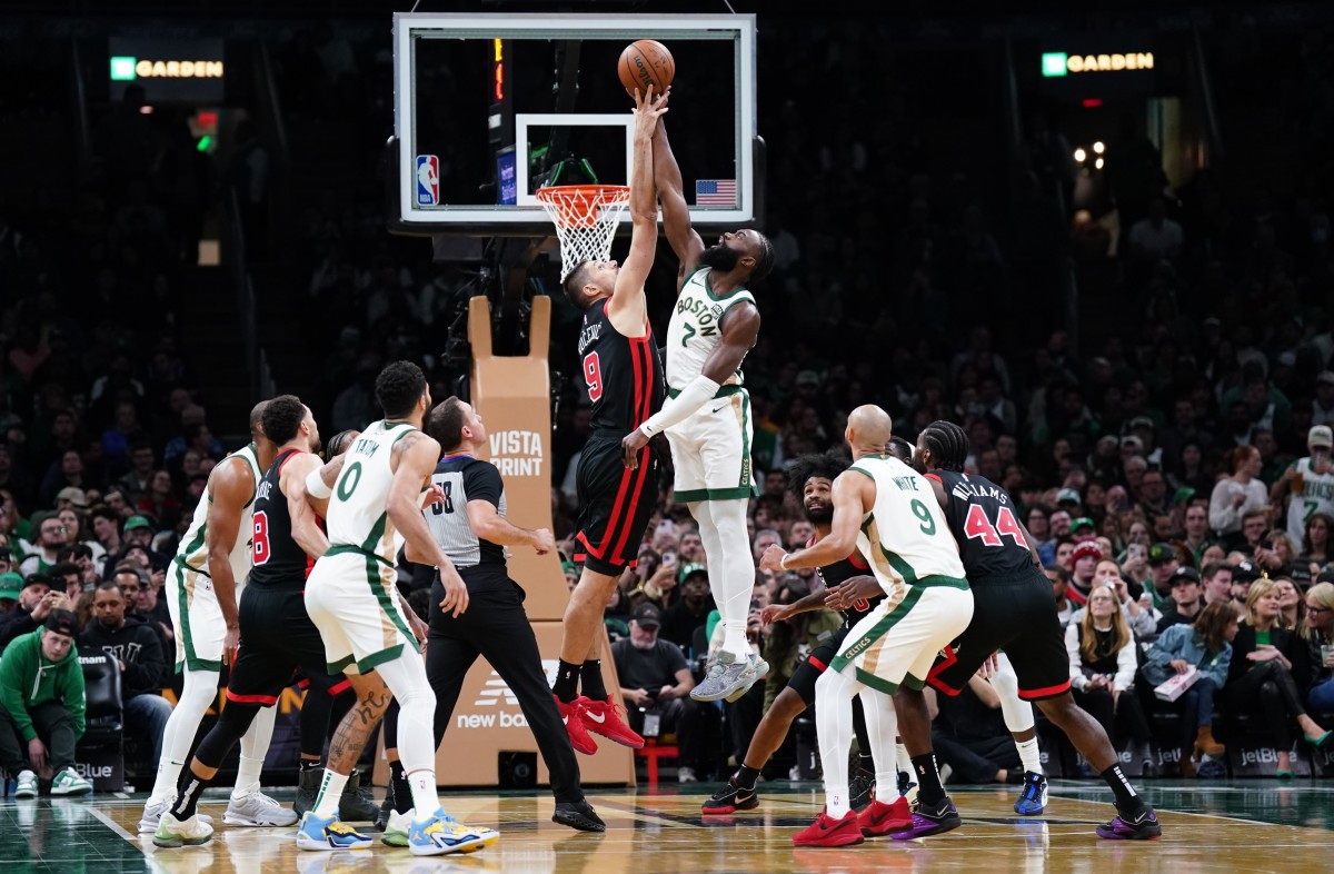 Boston Celtics guard Jaylen Brown (7) and Chicago Bulls center Nikola Vucevic (9) for a jump ball in the second half at TD Garden.