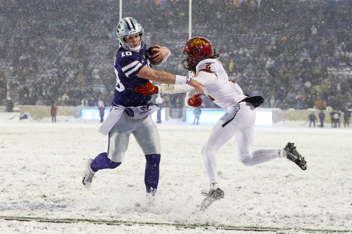 Nov 25, 2023; Manhattan, Kansas, USA; Kansas State Wildcats quarterback Will Howard (18) pushes away Iowa State Cyclones defensive back T.J. Tampa (2) on his way to a touchdown during the third quarter at Bill Snyder Family Football Stadium. Mandatory Credit: Scott Sewell-USA TODAY Sports