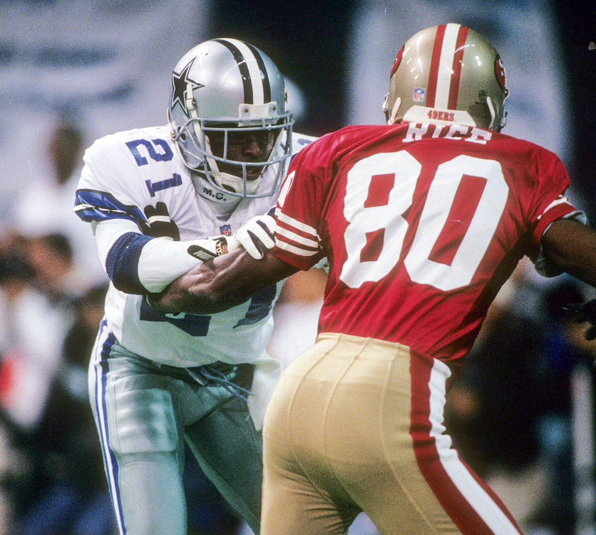 Cowboys cornerback Deion Sanders, left, covers 49ers receiver Jerry Rice