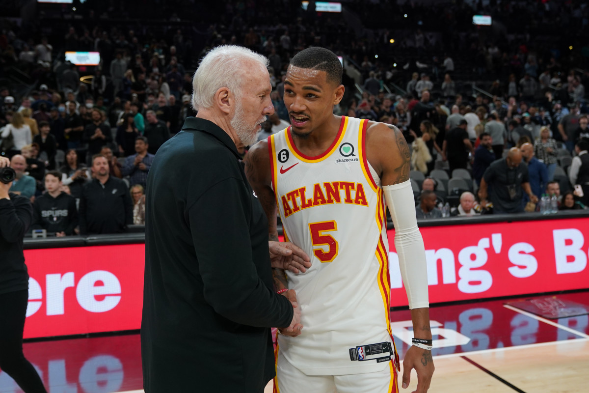 Mar 19, 2023; San Antonio, Texas, USA; San Antonio Spurs head coach Gregg Popovich talks with Atlanta Hawks guard Dejounte Murray (5) after the game at the AT&T Center.