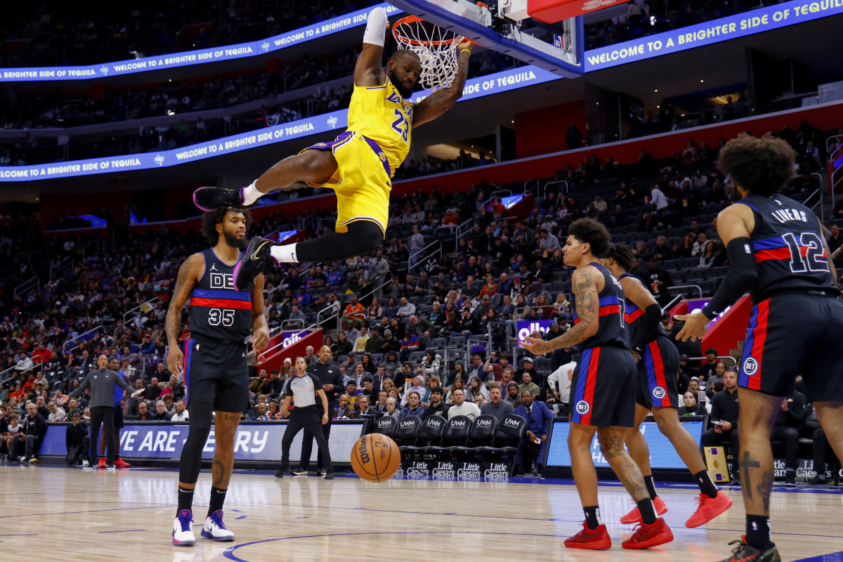 LeBron James dunks on Detroit Pistons forward Marvin Bagley III in the first half at Little Caesars Arena. The Lakers won the game, 133-107.