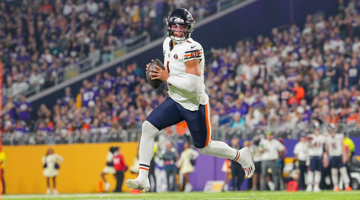Bears quarterback Justin Fields runs with the football during a game against the Vikings.