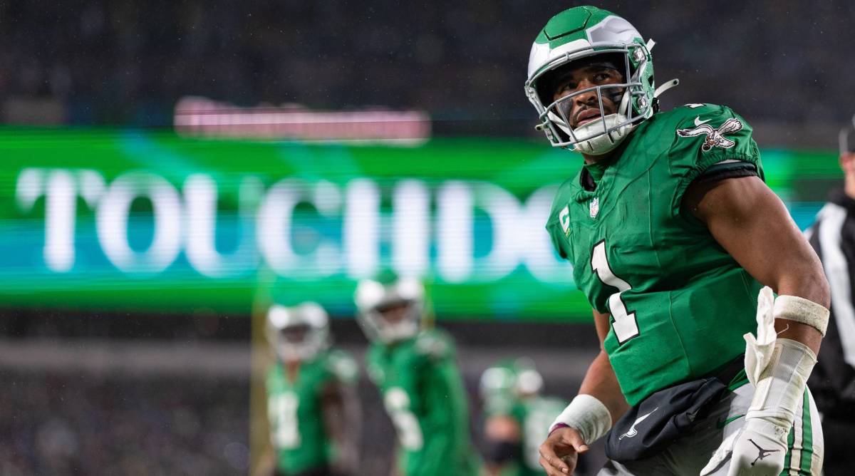 Eagles quarterback Jalen Hurts looks on after scoring a touchdown in a game.