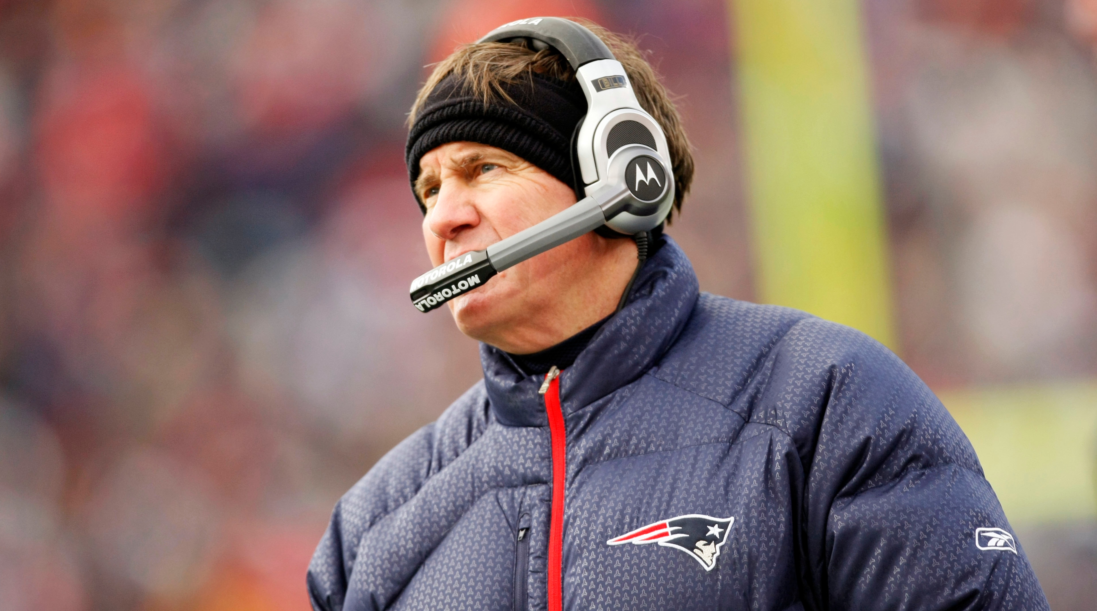 Patriots coach Bill Belichick looks on while wearing a headset during a game in the 2007 season.