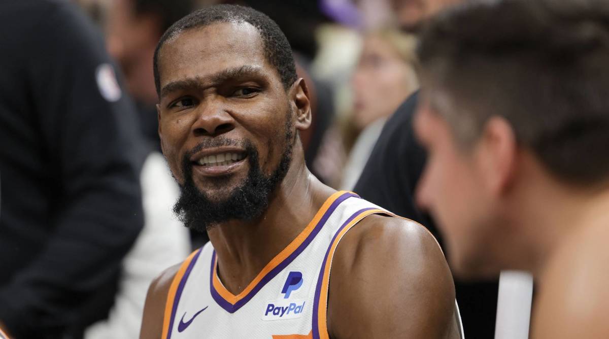 Suns forward Kevin Durant looks on while on the bench during a game.