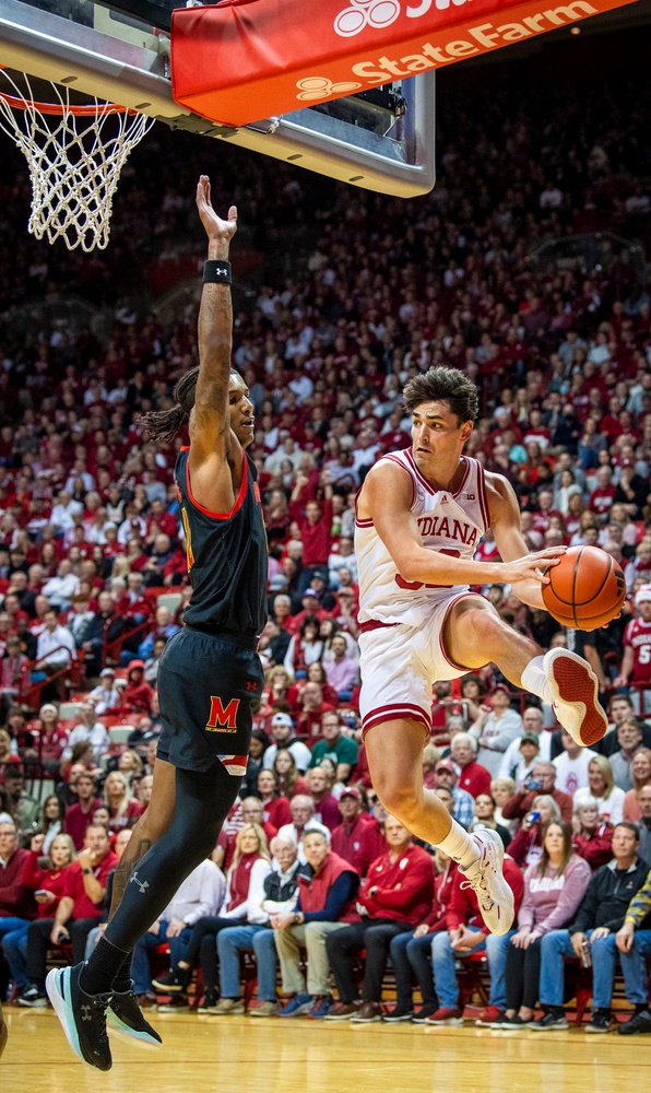 Trey Galloway slides a last minute dish off pass under the basket during the Indiana versus Maryland game.